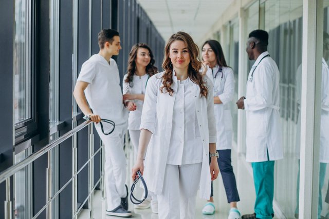 young-female-doctor-posing-corridor-hospital.jpg
