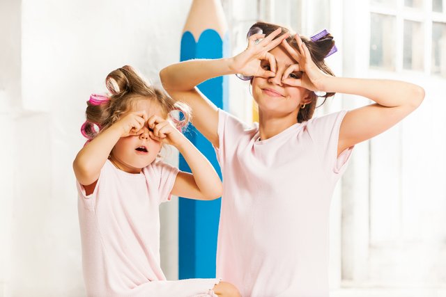 little-smiling-girl-playing-with-her-mother-white.jpg