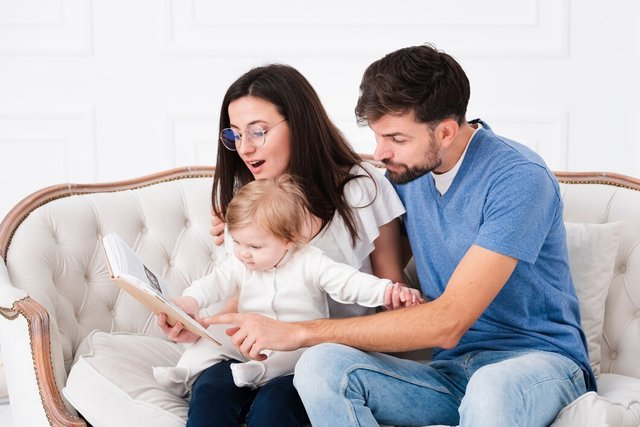 parents-reading-while-holding-baby_23-2148354797.jpg