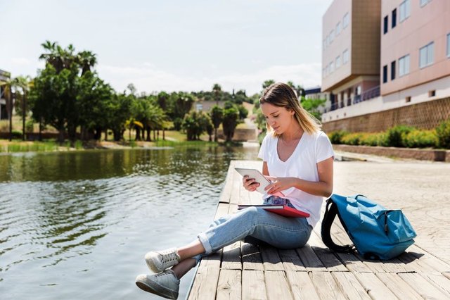 young-woman-with-tablet-campus-near-lake1.jpg