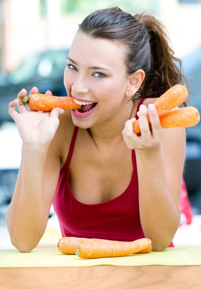 pretty-woman-eating-carrots-home_1301-6882.jpg