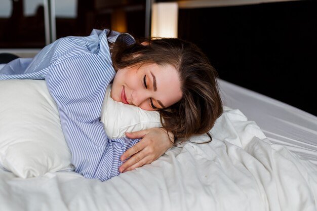 cute-woman-lying-her-stomach-bed-sleep-wearing-stylish-black-lingerie-striped-boyfriend-shirt_273443-3113.jpg