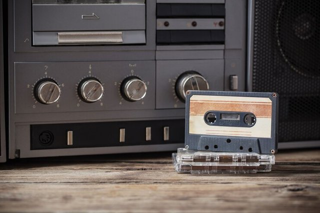 old-tape-recorder-cassette-wooden-table_201847-1.jpg