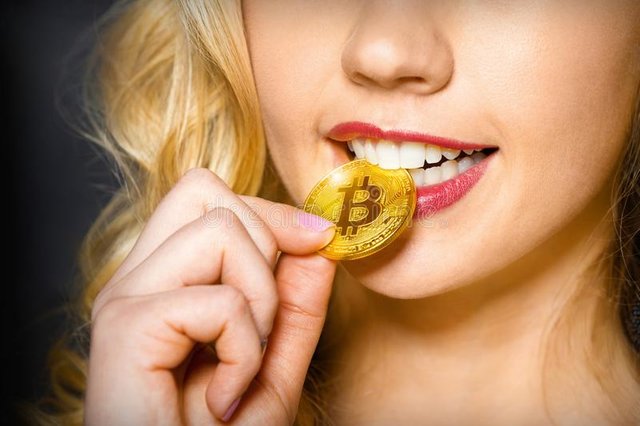 sexy-girl-holds-gold-coin-bitcoin-near-mouth-sexy-blonde-girl-checks-bitcoin-authenticity-help-her-teeth-110180257.jpg
