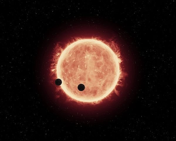 600px-Artist's_view_of_planets_transiting_red_dwarf_star_in_TRAPPIST-1_system(1).jpg