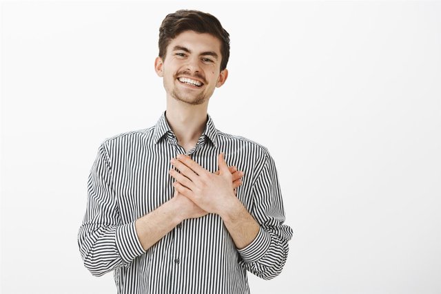 portrait-charming-happy-caucasian-man-with-beard-moustache-holding-palms-heart-smiling-from-satisfaction-being-touched-with-nice-gesture.jpg