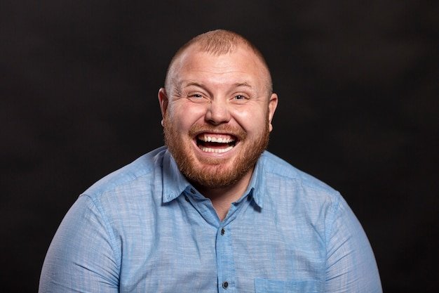 a-fat-red-haired-man-with-a-beard-and-mustache-in-a-blue-shirt-is-laughing_120897-597.jpg