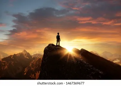 man-standing-on-top-mountain-260nw-1467369677.webp