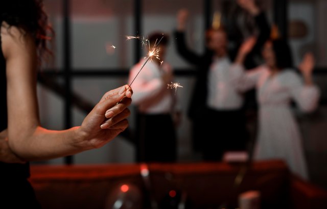 woman-holding-sparklers-at-new-year-s-eve-party-with-copy-space.jpg