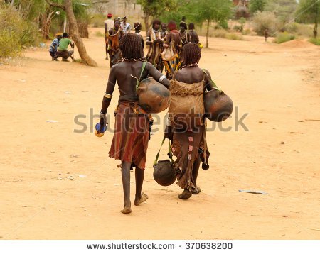 stock-photo-local-ethiopian-people-coming-back-from-the-market-from-the-turmi-village-in-the-omo-valley-in-370638200.jpg