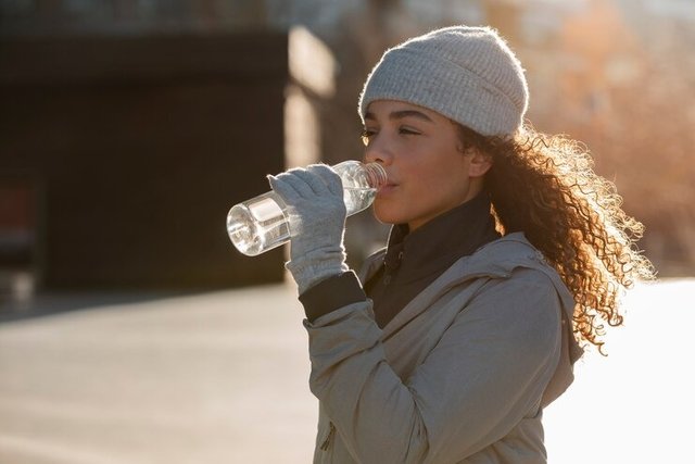 medium-shot-woman-drinking-water.jpg