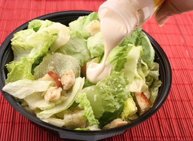 pouring-dressing-over-salad.webp