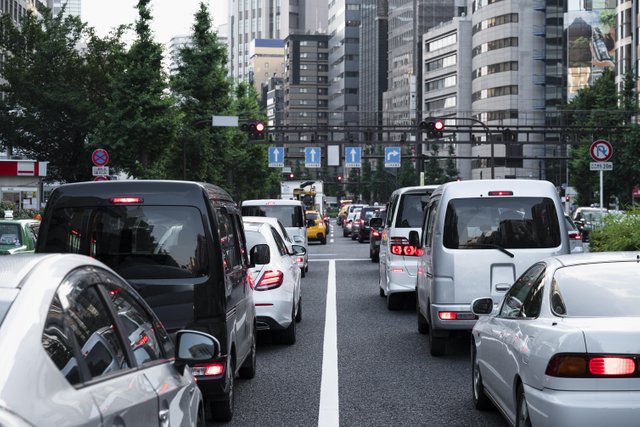 people-driving-cars-city-street.jpg