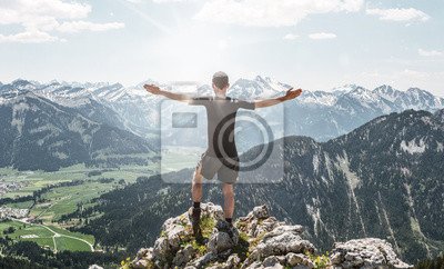 bright-sunlight-near-hiker-on-mountain-top-400-95010430.jpg