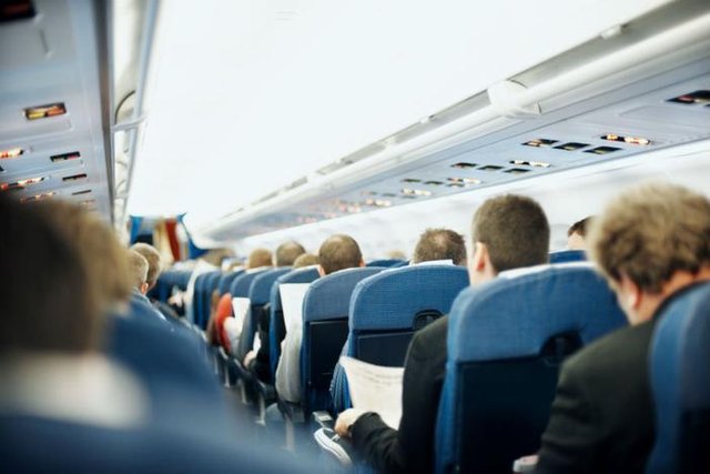 Airplane_passengers_cramped_seats_kupicoo_Getty_Images_large.jpg