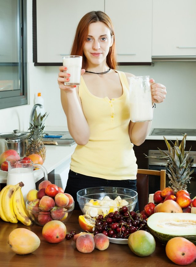 cheerful-housewife-drinking-milk-cocktail-with-fruits_1398-823.jpg