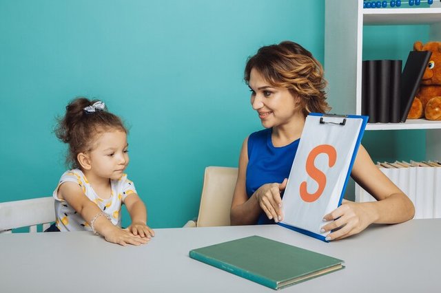 woman-with-kid-girl-training-speech-together-sitting-white-room_253401-1381.jpg