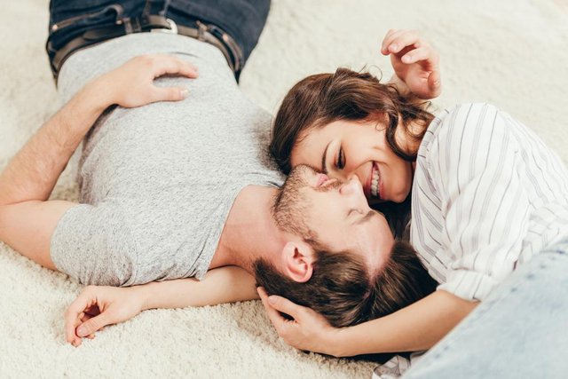 stock-photo-young-couple-lying-on-carpet.jpg