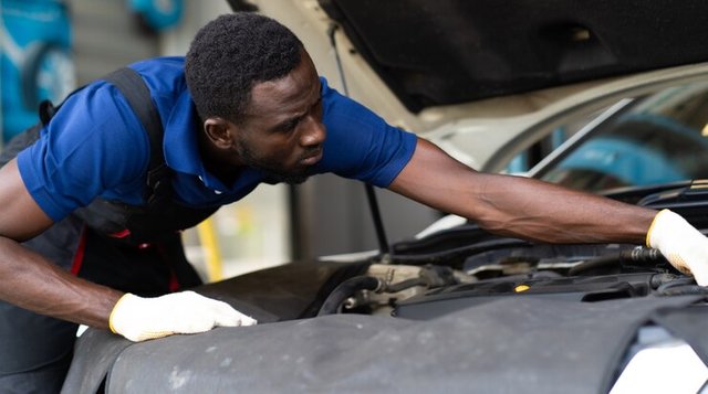 black-male-mechanic-repairs-car-garage-car-maintenance-auto-service-garage-concept_38052-1301.jpg