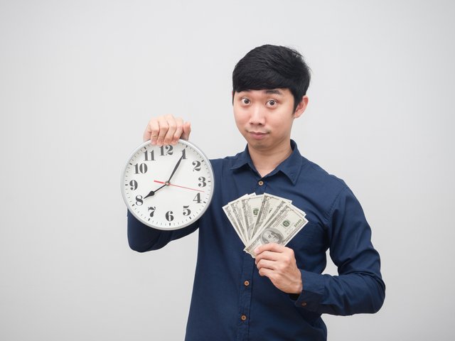 vecteezy_asian-man-holding-money-and-clock-in-hand-look-at-camera_16685568_563.jpg