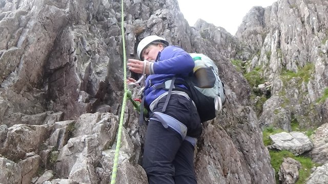 69 Closer one of Dawn declipping the carabiner and the sling from the rope. Can use.jpg