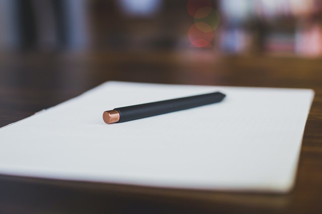 This is a picture of a  expensive looking pencil resting on a notebook for an article called  How to Think Within Competitive Intelligence Using Pencil and Paper by Octopus Competitive Intelligence Competitor Analysis focused on creating certainty .jpg