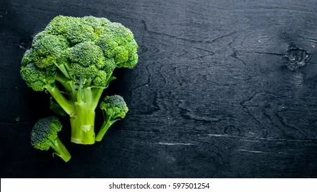 fresh-broccoli-on-dark-wooden-260nw-597501254.jpg