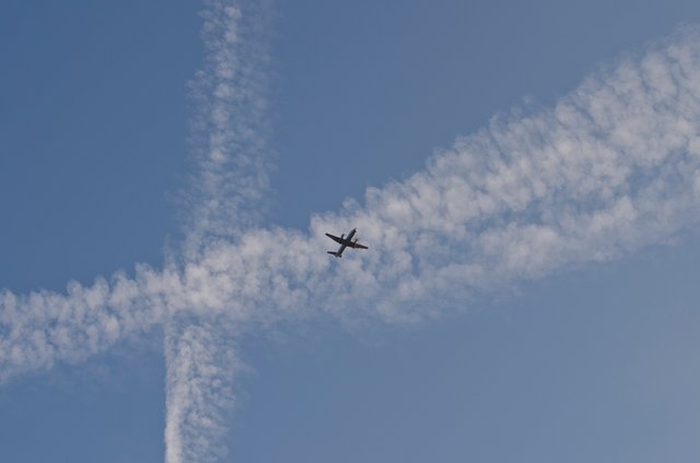 Blue sky and the x clouds with a plane.JPG