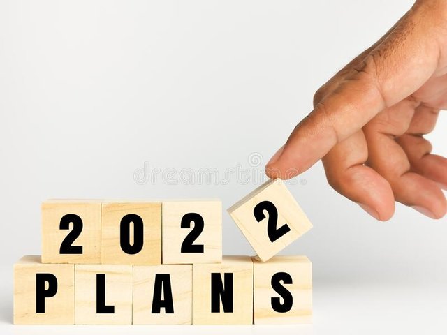 new-year-holiday-concepts-phrase-plan-wooden-cubes-human-hand-isolated-white-background-206401456.jpg