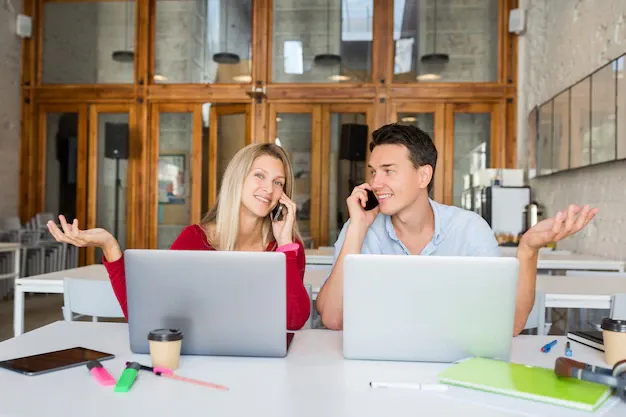 young-man-woman-working-laptop-open-space-co-working-office-room_285396-1706.webp