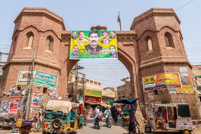 multan-delhi-gate-multan-delhi-gate-picturesque-view-rickshaw-walking-people-motorbikes-sunny-blue-sky-day-167709057.jpg