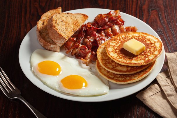 stock-photo-traditional-full-american-breakfast-eggs-pancakes-bacon-toast.jpeg