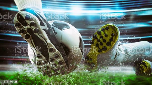 football-scene-at-night-match-with-close-up-of-a-soccer-shoe-hitting-the-ball-with-power.jpg