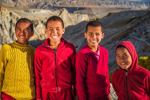 group-of-happy-novice-tibetan-monks-looking-tsarang-village-upper-mustang-nepal.jpg