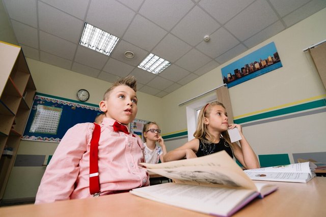 schoolchildren-sitting-table-with-textbooks_23-2147663608.jpg