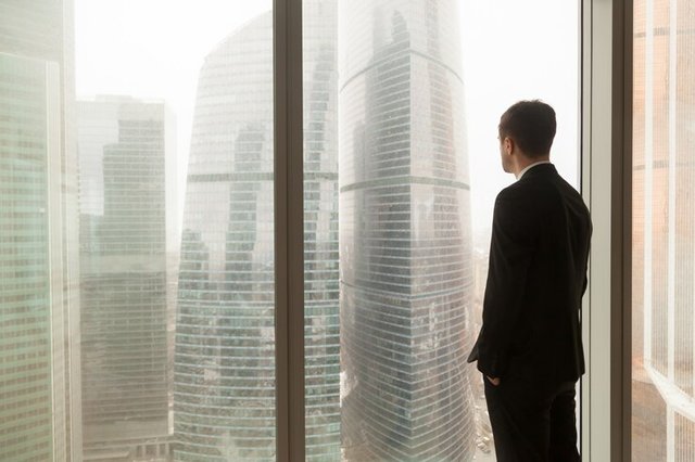 company-official-looking-through-window-office_1163-5331.jpg