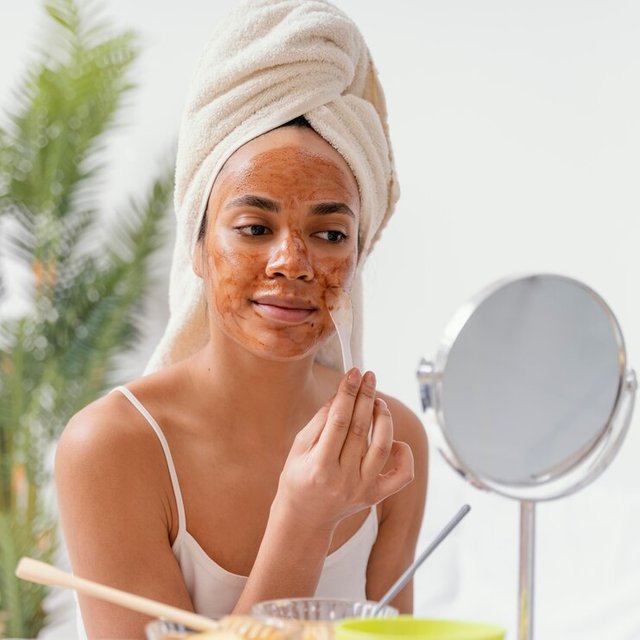 young-woman-applying-natural-face-mask_23-2148883859.jpg