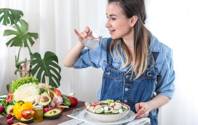 young-woman-drinks-water-table-with-vegetables-light-background-dressed-denim-clothes-healthy-food-drink-concept_169016-4640.jpg