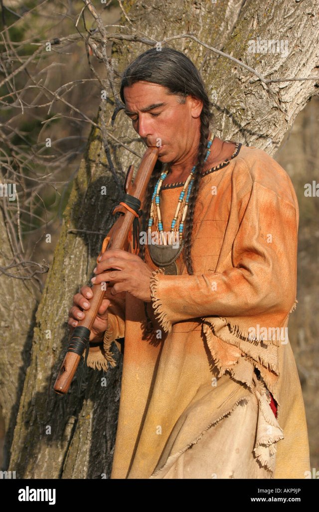 a-native-american-indian-man-playing-a-musical-flute-AKP9JP.jpg