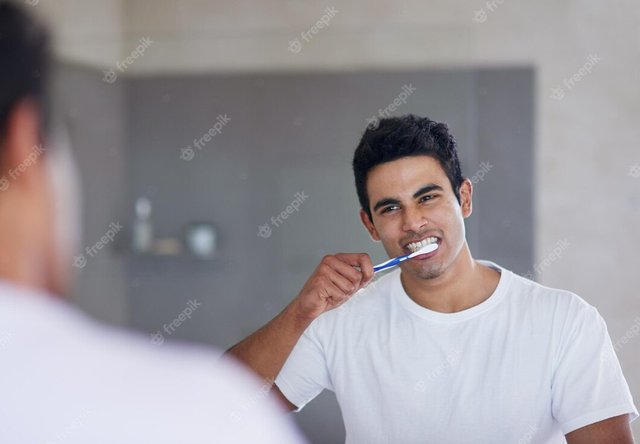 he-brushes-twice-daily-optimal-oral-health-shot-young-man-brushing-his-teeth-home_590464-21989.jpg