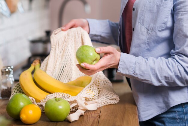 close-up-woman-getting-organic-fruits-out-eco-bag_23-2148454481.jpg