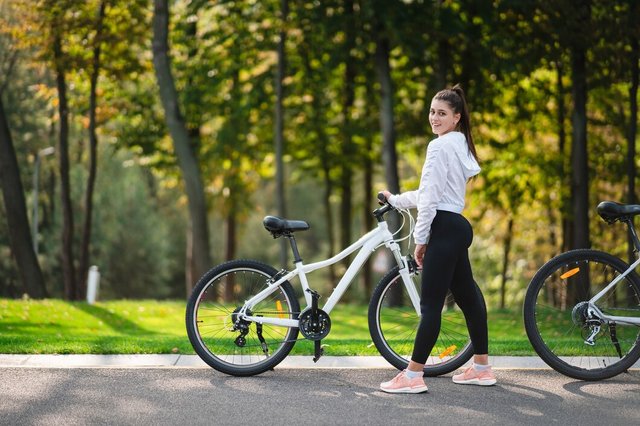 beautiful-young-woman-posing-white-bicycle_1153-7317.jpg