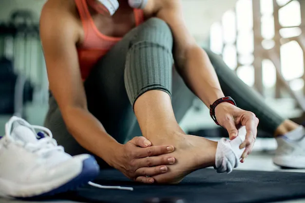 closeup-athletic-woman-injured-her-foot-during-workout-gym_637285-8520.webp