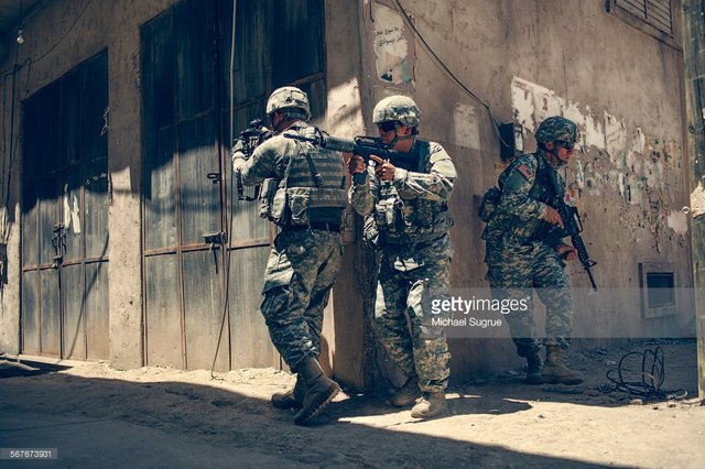 army-troops-advance-a-position-in-combat-picture-id567673931.jpeg