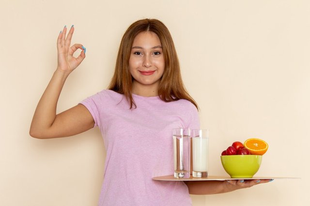 front-view-young-female-pink-t-shirt-blue-jeans-holding-tray-fruits-milk-water-smiling-grey_140725-21155.jpg