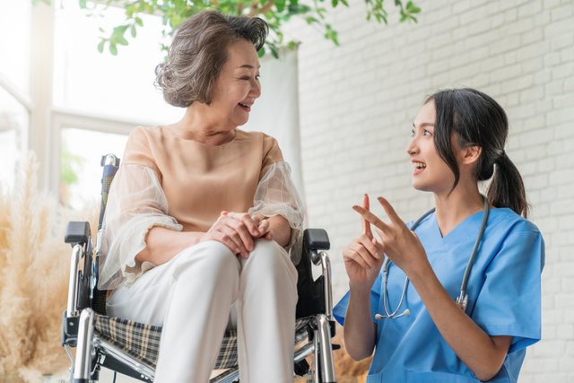 asian-young-caregiver-caring-her-elderly-patient-senior-daycare-handicap-patient-wheelchair-hospital-talking-friendly-nurse-looking-cheerful-nurse-wheeling-senior-patient.jpg
