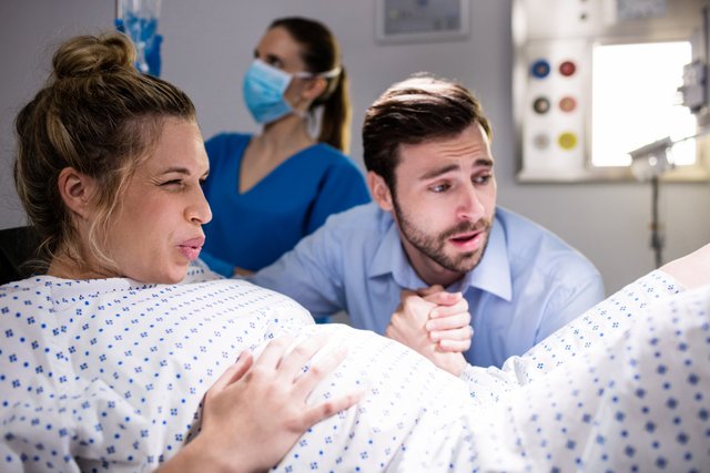 man-comforting-pregnant-woman-during-labor.jpg