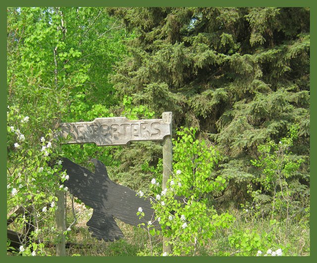 Porter sign with Saskatoon blooms beside.JPG