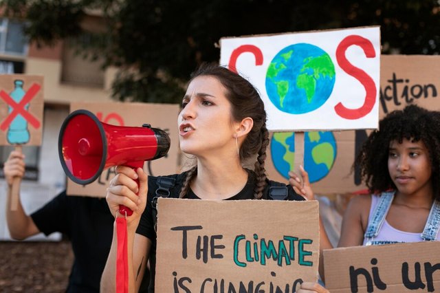 portrait-young-woman-protesting-against-climate-change_23-2149124667.jpg