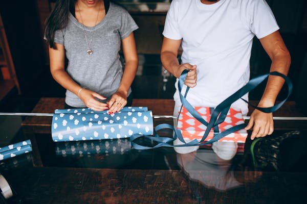 free-photo-of-midsection-of-a-young-couple-wrapping-christmas-presents.jpeg